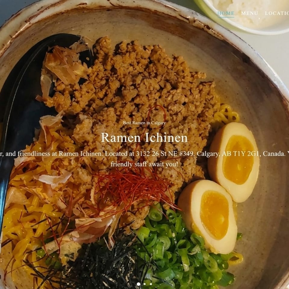 Rustic bowl of Ramen Ichinen with ground meat, soft-boiled eggs, green onions, and bonito flakes.